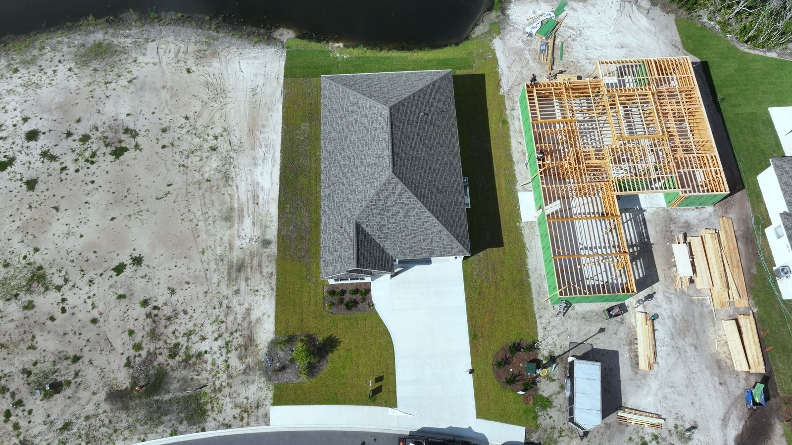 New home under construction beside finished homes, Camden County