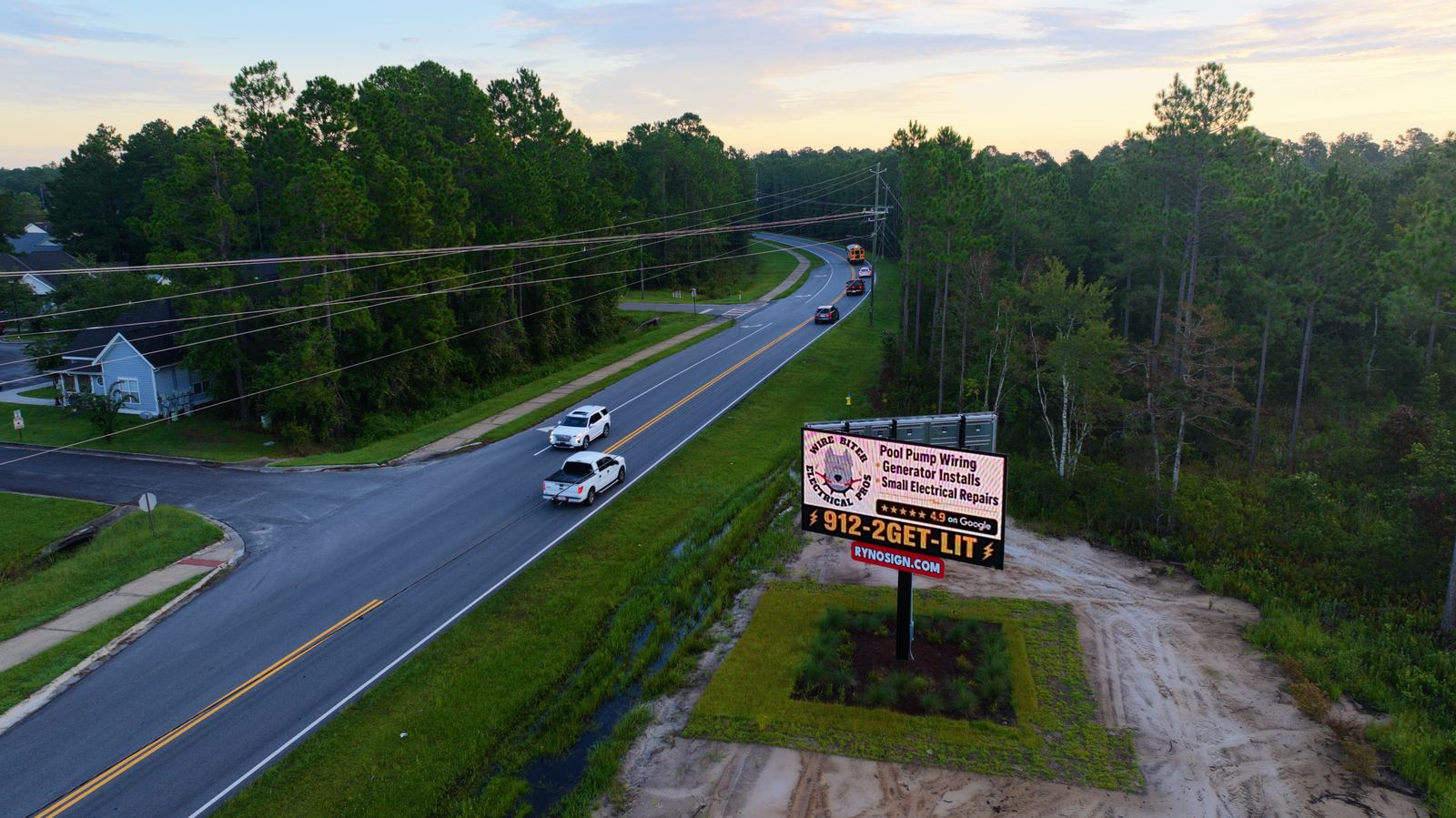 Highway billboard photographed at dusk